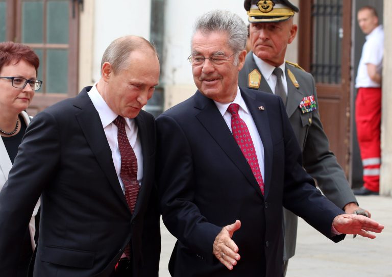 Austrian President Heinz Fischer, right, and Russian President Vladimir Putin, left,talk during a welcoming ceremony in front of the Hofburg palace in Vienna, Austria, Tuesday, June 24, 2014. (AP Photo/Ronald Zak)