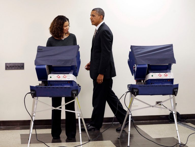 President Barack Obama walks away from the voting machine after casting his vote, during early voting, at the Martin Luther King Community Center in Chicago. (AP Photo)