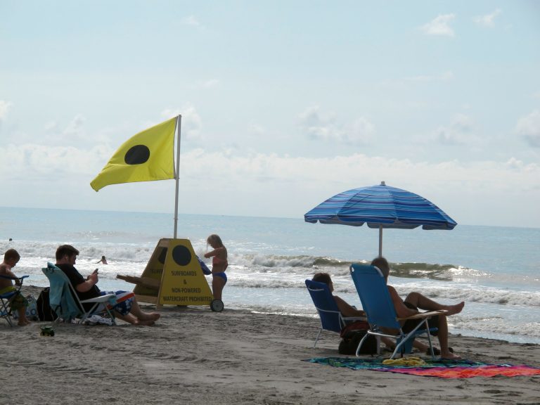 Vacationers enjoy the shore at Folly Beach, S.C., on July 1, 2014. On Friday, July 18, 2014 the Obama Administration announced it was opening the Eastern Seaboard to oil and gas exploration for the first time in decades. Environmental groups have expressed concern that offshore energy rigs and the potential for spills could harm South Carolina's $18 billion tourism industry.  (AP Photo/Bruce Smith)