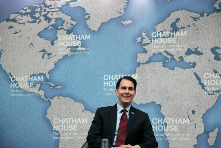 Wisconsin Gov. Scott Walker sits as he is being introduced prior to his speech at Chatham House in central London, Wednesday. (AP/Lefteris Pitarakis)
