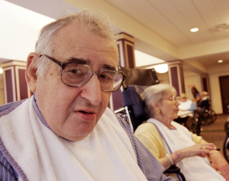 Arnold Heart, 79, sits at the table during the evening meal as Margaret Sommerville, background, talks at the Daughters of Sarah nursing home in Albany, N.Y. (AP Photo)Â 