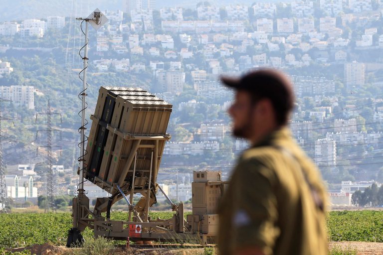   An Israeli soldier is seen next to an Iron Dome rocket interceptor battery deployed near the northern Israeli city of Haifa, Wednesday, Aug. 28, 2013. Israel ordered a special call-up of reserve troops Wednesday as nervous citizens lined up at gas-mask distribution centers, preparing for possible hostilities with Syria. (AP Photo/Tsafrir Abayov)  