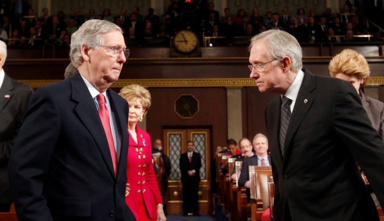 Senate Minority Leader Mitch McConnell, left, and Senate Majority Leader Harry Reid head to the front of the chamber before President Obama delivers his State of the Union speech on Capitol Hill in Washington, Tuesday, Jan. 28, 2014. (AP Photo/Larry Downing, Pool)