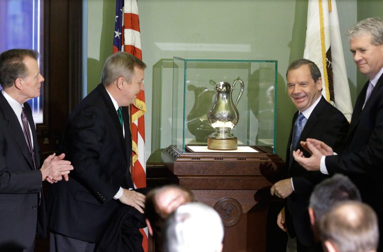 U.S. Sen. Dick Durbin, second from left, Illinois Speaker of the House Michael Madigan, D-Chicago, left, Illinois Senate President John Cullerton, D-Chicago, second from right, and Illinois House Minority Leader Jim Durkin, R-Western Springs, right, present a silver pitcher given to a 19th century Illinois senator that's been absent from the state for nearly 150 years to the Illinois State Capitol Friday, May  30, 2014, in Springfield Ill. (AP Photo/Seth Perlman)