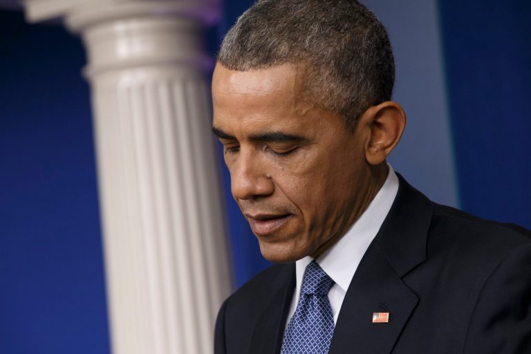President Barack Obama pauses during a news conference in the Brady Press Briefing Room of the White House in Washington, Friday, Dec. 19, 2014. (AP Photo/J. Scott Applewhite)