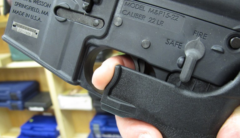 A gun store employee demonstrates how a 