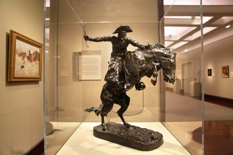 A Frederic Remington bronze statue of a cowboy riding a bucking horse, part of a collection on display inside the Denver Art Museum, Monday, Jan. 27, 2014. In a friendly wager announced Monday, if the Broncos win the Super Bowl against the Seahawks Sunday, the Seattle Art Museum will send a Seahawk mask from its North Coast Native American collection to Denver for three months. If the Seahawks win, the Seattle museum gets the Remington statue for three months. (AP Photo/Brennan Linsley)
