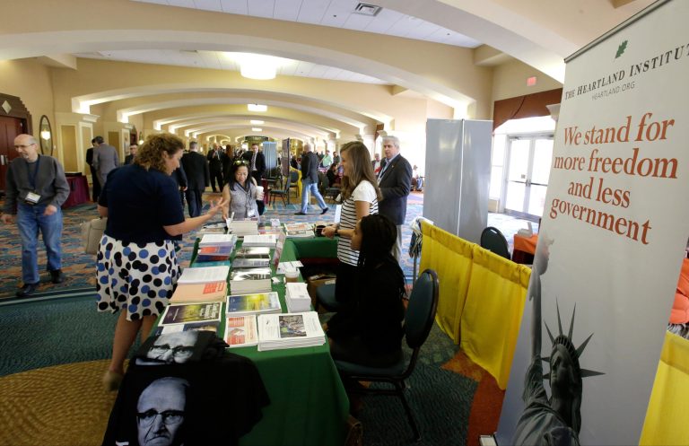 Delegates stop by one of the many information booths at the National Libertarian Party Convention. (AP Photo/John Raoux)