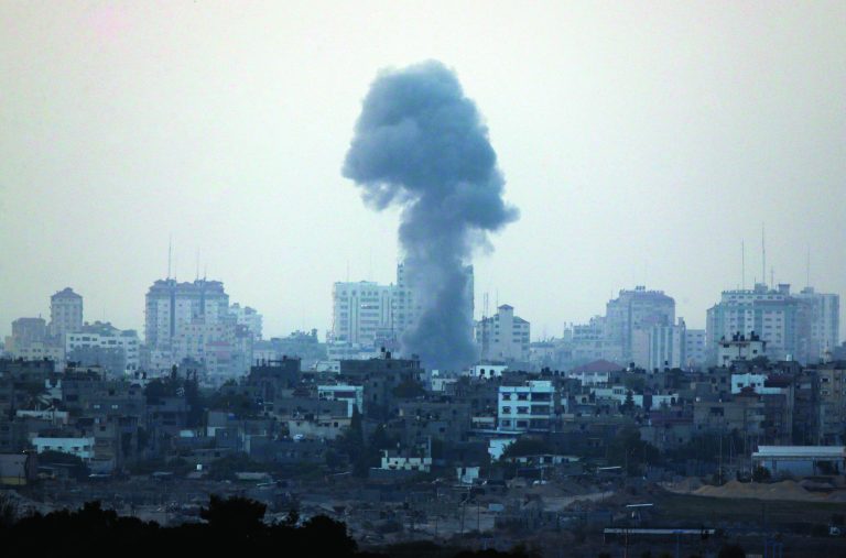 A plume of smoke is seen over central Gaza Strip, after an airstrike by Israeli forces, as seen from the Israel Gaza border, Monday, Nov. 19, 2012. Israeli aircraft struck crowded areas in the Gaza Strip and killed a senior militant with a missile strike on a media center Monday, driving up the Palestinian death toll to 96, as Israel broadened its targets in the 6-day-old offensive meant to quell Hamas rocket fire on Israel. (AP Photo/Lefteris Pitarakis)