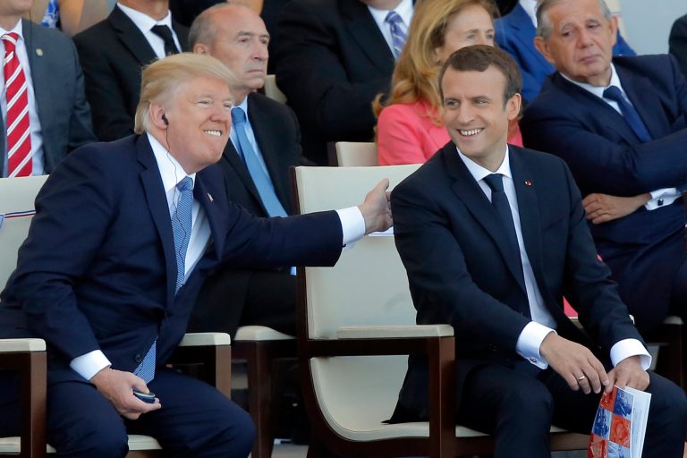 FILE - A Friday, July 14, 2017 file photo of French President Emmanuel Macron, right, and U.S. President Donald Trump attending the traditional Bastille Day military parade on the Champs Elysees, in Paris. Less than three months after his election, French President Emmanuel Macron faces a sharp fall in popularity according to recent opinion polls, after launching labor reform, budget cuts and a damaging dispute with the military. (AP Photo/Michel Euler, File)