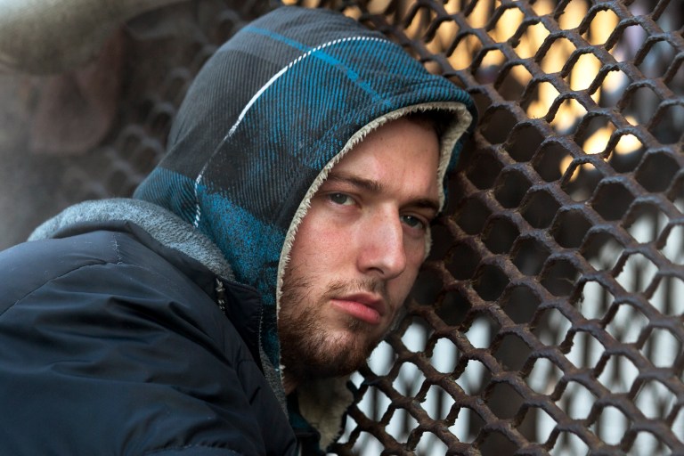 Nick warms himself on a steam grate with three homeless men by the Federal Trade Commission, just blocks from the Capitol, during frigid temperatures in Washington, Saturday, January 4, 2014. (AP Photo/Jacquelyn Martin)
