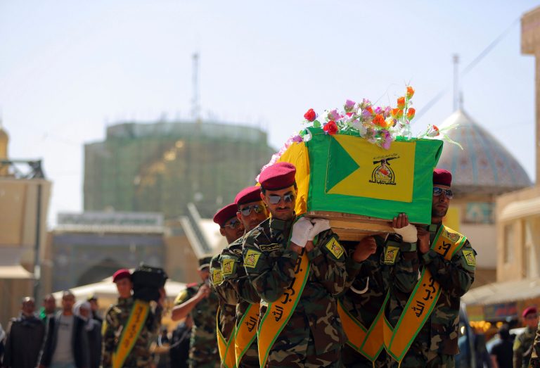 Iraqi Hezbollah fighters carry the coffin of their comrade, Ali Mansour, who his family says was killed in Tikrit fighting Islamic militants, during his funeral procession, in the city of Najaf, 100 miles) south of Baghdad, Iraq, Monday, March 2, 2015. (AP Photo/Jaber al-Helo)