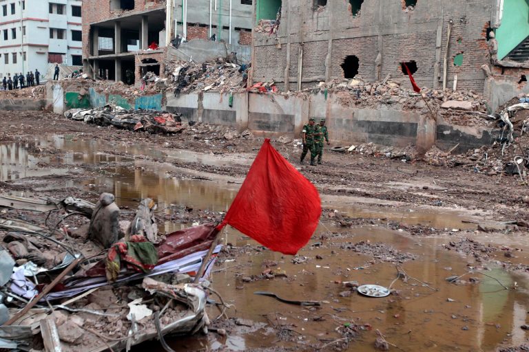 Bangladeshi soldiers walk at the site where a Bangladesh garment-factory building collapsed on April 24 in Savar, near Dhaka, Bangladesh, Monday, May 13, 2013. Nearly three weeks after the building collapsed, the search for the dead ended Monday at the site of the worst disaster in the history of the global garment industry. The death toll: 1,127.(AP Photo/A.M. Ahad)