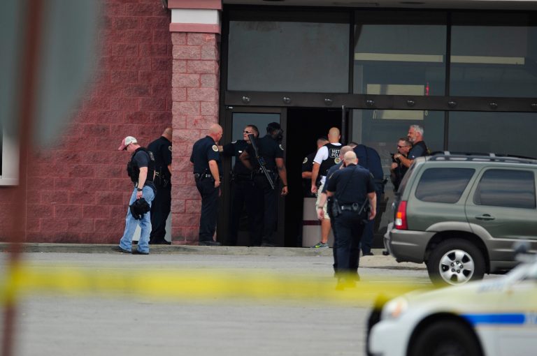 Police work the scene of a reported shooting in Nashville, Tenn., Wednesday, Aug. 5, 2015. A suspect wielding a hatchet and a gun inside a Nashville-area movie theater died after exchanging gunshots with a police team that stormed the theater, police said Wednesday. (John Partipilo/The Tennessean via AP)