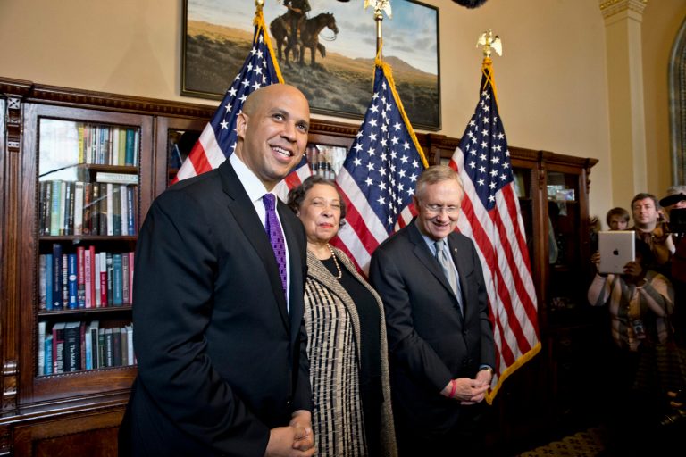 Newly-elected Democratic senator from New Jersey, former Newark Mayor Cory Booker, left, and his mother, Carolyn Booker, meet with Senate Majority Leader Harry Reid of Nev., before being officially sworn in on the floor of the Senate, Thursday, Oct. 31, 2013, on Capitol Hill in Washington.  (AP Photo/J. Scott Applewhite)