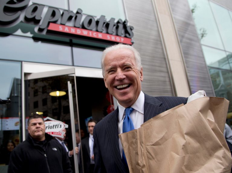 Vice President Joe Biden carries a bag full of food as he talks with reporters outside Capriotti's Sandwich Shop in Washington, Thursday, Nov. 21, 2013. He entered the 2020 race today and already leads in Wisconsin.