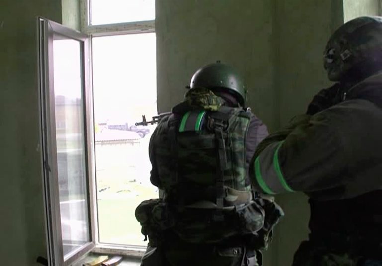 Police special force officers aim their guns during a shootout with militants on the outskirts of the provincial capital Makhachkala, Russia's southern province of Dagestan, Saturday, Jan. 18, 2014. The province of Dagestan, located between Chechnya and the Caspian Sea, about 500 kilometers (300 miles) east of Sochi, has become the epicenter of the rebellion, with daily shootings and bombings of police and other officials. President Vladimir Putin vowed Friday that Russia will do everything to ensure a safe Olympics without making the security measures too intrusive. (AP Photo/NewsTeam)
