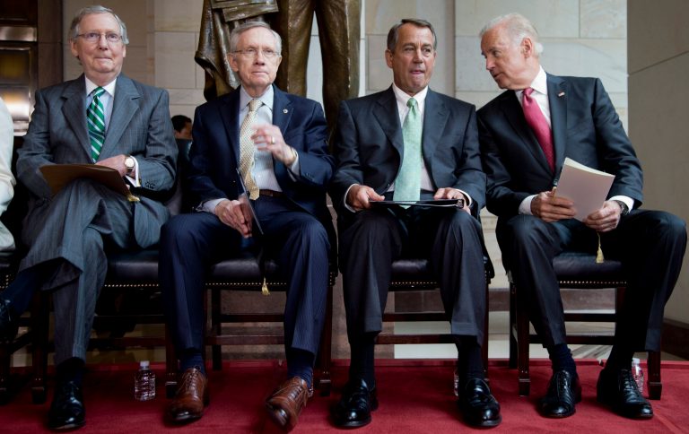 From left, Senate Minority Leader Mitch McConnell of Ky., Senate Majority Leader Harry Reid of Nev., House Speaker John Boehner of Ohio and Vice President Joe Biden sit together during a ceremony to dedicate the statue of Frederick Douglass in the Emancipation Hall of the United States Visitor Center on Capitol Hill in Washington, Wednesday. (AP Photo/Carolyn Kaster)