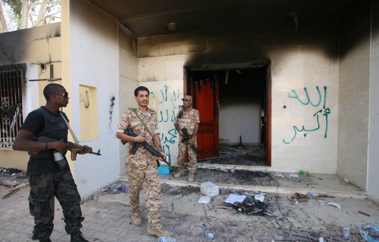 FILE - In this Friday, Sept. 14, 2012 file photo, Libyan military guards check one of the U.S. Consulate's burnt out buildings during a visit by Libyan President Mohammed el-Megarif, not shown, to the U.S. consulate in Benghazi, Libya to express sympathy for the death of the American ambassador, Chris Stevens and his colleagues in the deadly Sept. 11, 2012 attack on the consulate. (AP Photo/Mohammad Hannon, File)