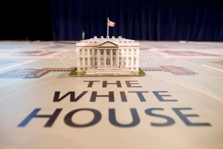   In this Dec. 12, 2012, photo, a model of the White House sits on a giant map during a media tour highlighting inaugural preparations being made by the Joint Task Force-National Capital Region for military and civilian planners at the DC Armory in Washington. The Presidential Inaugural Committee has begun sending out invitations to groups nationwide to march behind Obama from his swearing in at the Capitol to the White House on Jan. 21. The first wave selected includes the marching band from Miami University of Ohio, the alma matter of GOP vice presidential nominee Paul Ryan where first lady Michelle Obama spoke during the final weekend of the campaign. Also selected was the Virginia Military Institute that is a traditional performer in inaugural parades. (AP Photo/ Evan Vucci)  