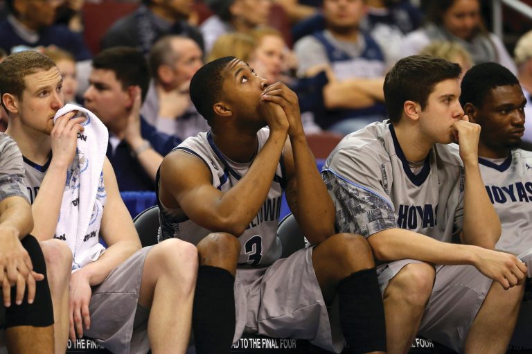 Elsa/Getty Images
Mikael Hopkins, center, of the Georgetown Hoyas sits on the bench dejected with teammates after losing the Florida Gulf Coast Eagles on Friday night.