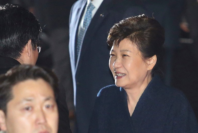 Ousted South Korea President Park Geun-hye, smiles as she is greeted by supporters upon her arrival at her private home in Seoul, South Korea, Sunday, March 12, 2017. (AP Photo/Ahn Young-joon)