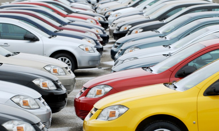 FILE - In this Friday, Dec. 12, 2008, file photo, rows of cars sit on the lot at the Lordstown, Ohio The families of three teenagers killed or injured in a 2006 Wisconsin car crash are suing General Motors, alleging that the company was negligent in designing its small cars and committed fraud by not disclosing facts about the defects. (AP Photo/Mark Stahl)