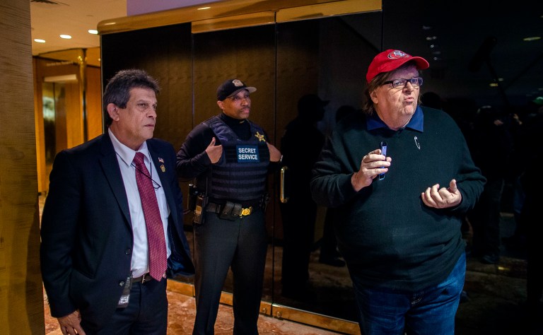 Filmmaker Michael Moore, right, reacts as Secret Service block him to access to restricted areas inside Trump Tower in New York on Saturday. (AP Photo/Andres Kudacki)