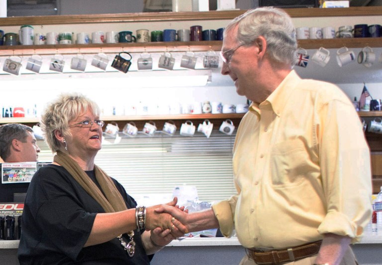 U.S. Senator Mitch McConnell meets Patty Carter of Wickliffe and other supporters during a fly-in visit, Thursday, Sept. 4, 2014 at Rudy's Farm Center in Kevil, Ky. (AP Photo/The Paducah Sun, John Paul Henry)