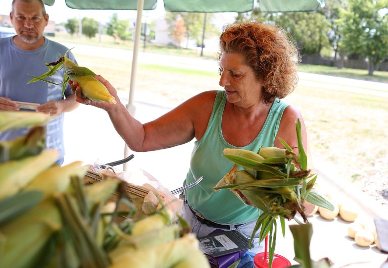 GRIMES, IA - AUGUST 07:  Grimes Sweetcorn worker Paulette Vandyke helps a customer purchase fresh corn at a Kum N' Go gas station on August 7, 2012 in Grimes, Iowa.  An exceptionally hot summer and the worst drought in more than a half century has caused cut prospects for the U.S. corn crop to a five-year low and has sent prices up to over $8.00 a bushel in late July trading. The price surge and limited supply has also prompted ethanol plants to voluntarily slow production by 20 percent, a two year low. (Photo by Justin Sullivan/Getty Images)