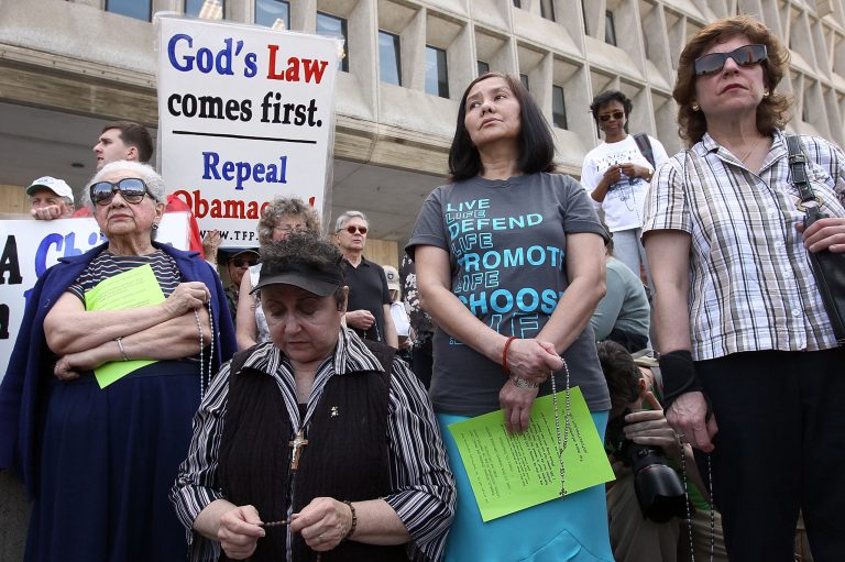 Protesters pray while participating in a 'Stand Up for Religious Freedom' rally in front of the Department of Health and Human Services March 23, 2012 in Washington. (Photo by Win McNamee/Getty Images)