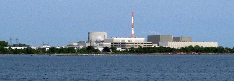 In this Sunday, June 1, 2014 photo, the Millstone Power Station nuclear power complex in Waterford, Conn., is seen from the shore in East Lyme, Conn. Federal regulators began inspecting the plant on Monday, June 2, 2014, more than a week after a power failure forced both units to shut down and water was found to be slightly radioactive. (AP Photo/Dave Collins)