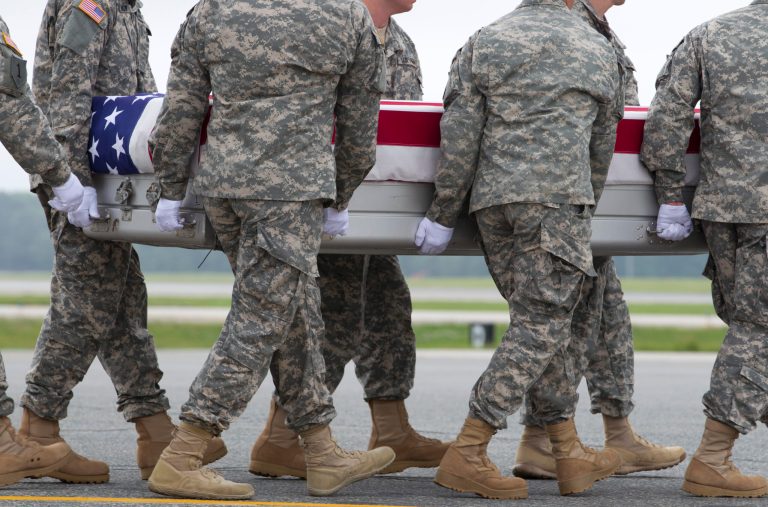 An Army carry team carries the transfer case containing the remains of Army Spc. Justin R. Helton of Beaver, Ohio, upon arrival at Dover Air Force Base, Del. on Thursday, June 12, 2014. (AP Photo/Jose Luis Magana)