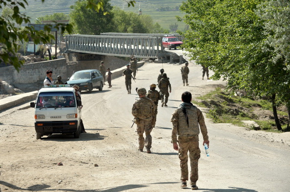 Soldiers of the 2nd Platoon Alfa Company of Combined Team Bastogne, 1st Brigade Combat Team, 101st Airborne Division (Air Assault) and personel of Afghan National Army patrol the Watahpur river area during a visit by the Provincial Reconstruction Team (PRT) to the Shamirkot Bridge near the forward base Honaker Miracle in Kunar province on April 14, 2013. The PRT visited the Shamirkot Bridge to make an assessment of its reconstruction. (Manjunath Kiran/AFP/Getty Images)