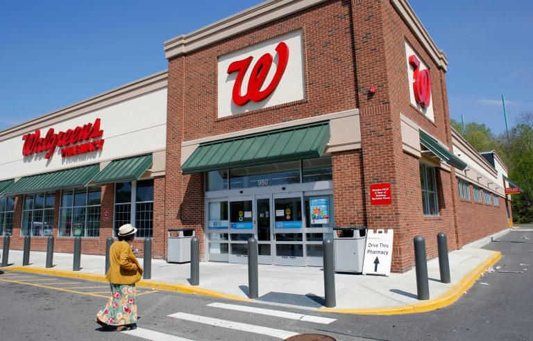 In this Wednesday, May 14, 2014 photo, a customer walks toward an entrance to a Walgreens store, in Boston. Walgreen plans to keep its roots firmly planted in the United States, saying Wednesday, Aug. 6, 2014 it will no longer pursue an overseas reorganization that would have trimmed the amount of U.S. taxes it pays. (AP Photo/Steven Senne)