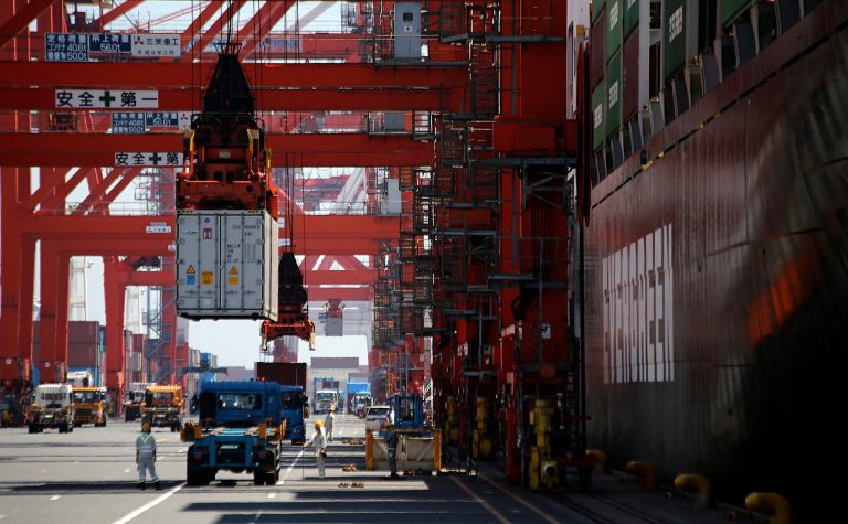 A cargo is unloaded from a truck to load onto a freight vessel at the pier of a container terminal in Tokyo, Wednesday, Aug. 20, 2014. Japan's trade deficit rose in July from the month before to a wider than expected 964 billion yen ($9.4 billion), though exports were higher for the first time in three months, the government said Wednesday. (AP Photo/Eugene Hoshiko)