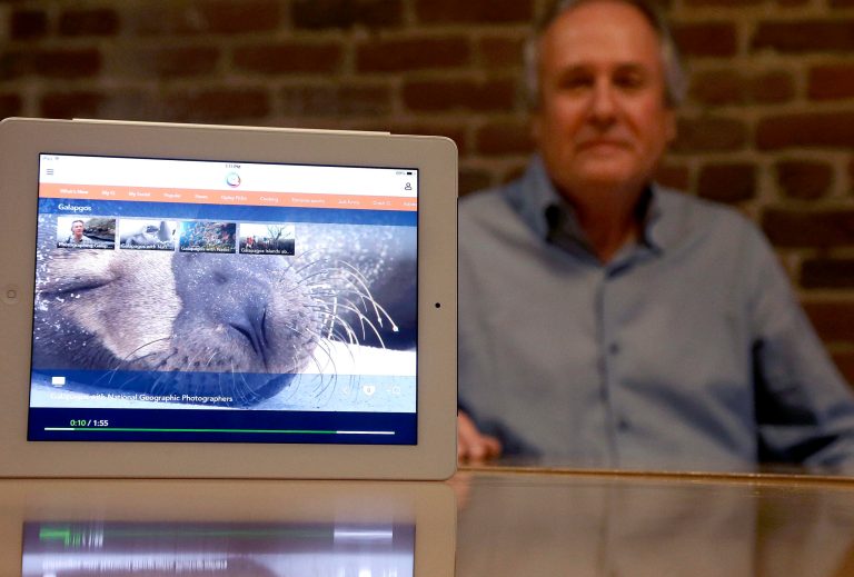 In this Friday, Feb. 21, 2014, photo, Mike Ramsay, CEO of Qplay, poses for photographs after giving a demonstration of Qplay on a tablet device in San Francisco. (AP Photo/Jeff Chiu)