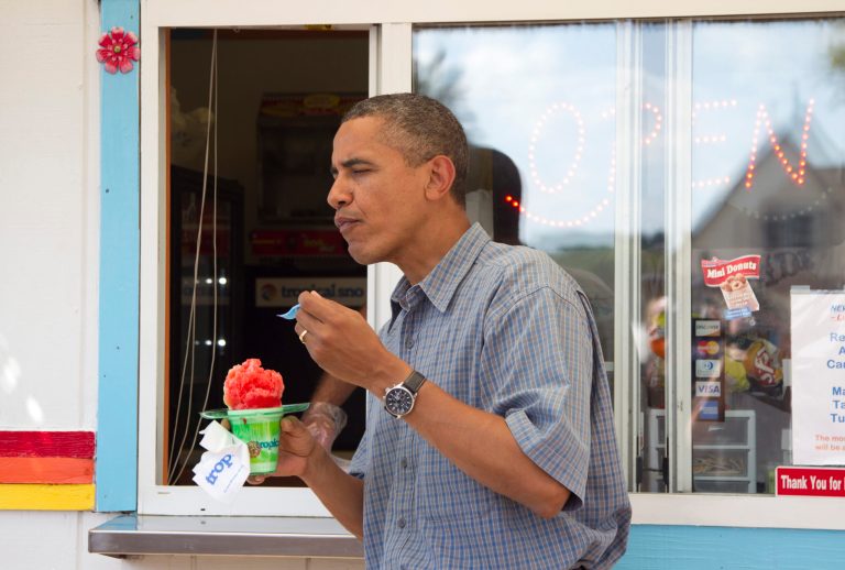 President Obama eats his snow cone. (AP Photo/Carolyn Kaster)