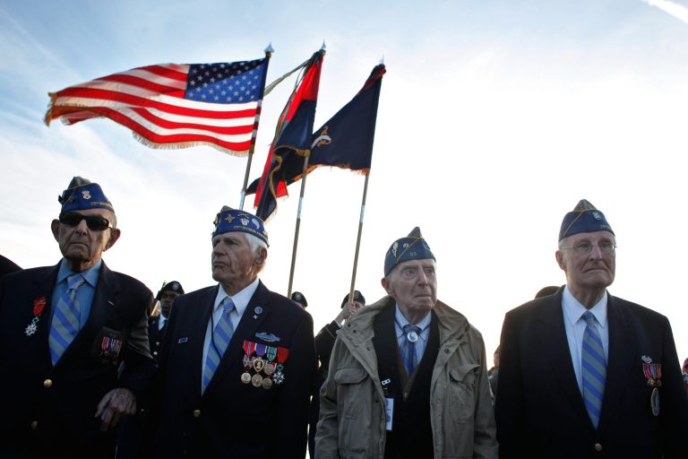 From left, World War II veterans of the U.S. 29th Infantry Division, Hal Baumgarter, 90 from Pennsylvania, Steve Melnikoff, 94, from Rhode Island, Don McCarthy, 90 from Maryland, and Morley Piper, 90, from Massachusetts, attend a D-Day commemoration, on Omaha Beach, western France , Friday June 6, 2014. Veterans and Normandy residents are paying tribute to the thousands who gave their lives in the D-Day invasion of Nazi-occupied France 70 years ago. World leaders and dignitaries including President Barack Obama and Queen Elizabeth II will gather to honor the more than 150,000 American, British, Canadian and other Allied D-Day troops who risked and gave their lives to defeat Adolf Hitler's Third Reich. (AP Photo/Thibault Camus)