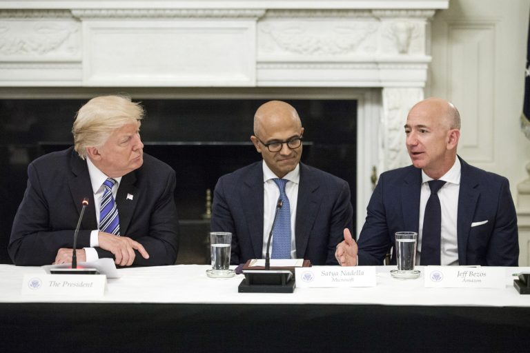 Jeff Bezos, president and chief executive officer of Amazon.com Inc., right, speaks as President Trump, left, and Satya Nadella, chief executive officer of Microsoft Corp., listen during the American Technology Council roundtable hosted at the White House on June 19.
		(Zach Gibson/Bloomberg)
