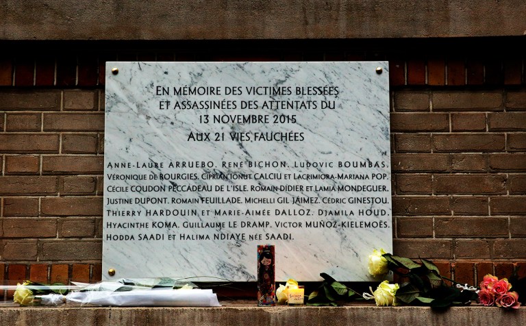 A commemorative plaque is seen next to La Belle Equipe restaurant, in Paris, Sunday, Nov. 13, 2016. A Dec. 4 coalition airstrike in Syria killed three Islamic State leaders, including two facilitators of the Nov. 13, 2015, terrorist attacks in Paris, according to the Pentagon. (AP Photo/Christophe Ena)
