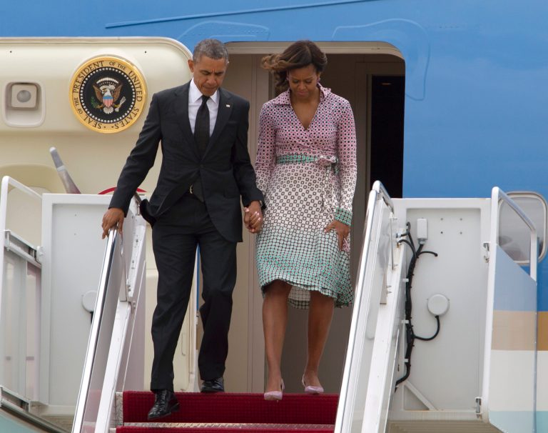 President Obama and first lady Michelle Obama walk down the stairs of Air Force One. (AP/Jose Luis Magana)