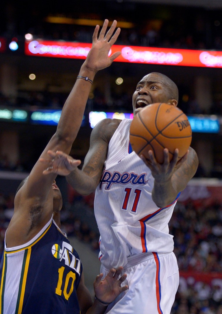   Los Angeles Clippers guard Jamal Crawford, right, goes up for a shot as Utah Jazz guard Alec Burks defends during the second half of their NBA basketball game, Sunday, Dec. 30, 2012, in Los Angeles. The Clippers have 107-96. (AP Photo/Mark J. Terrill)  