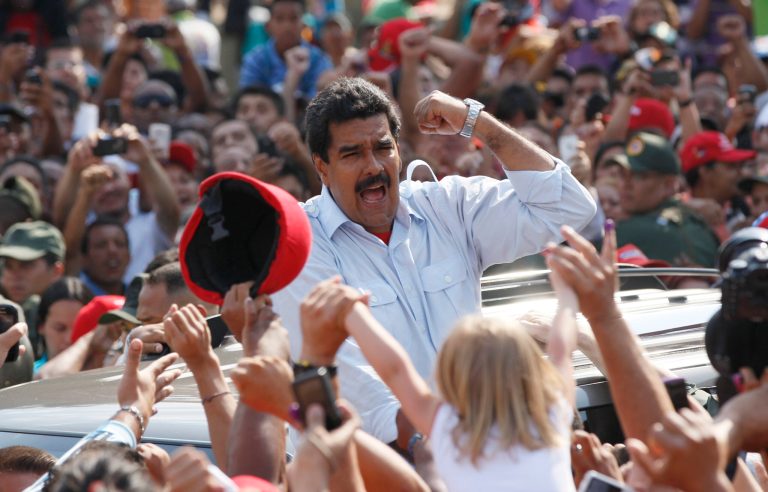 Venezuela's interim President Nicolas Maduro gestures to supporters as he leaves a polling station after voting in the presidential election in Caracas, Venezuela, Sunday, April 14, 2013. Maduro, who served as late President Hugo Chavez's foreign minister and vice president, is running against opposition candidate Henrique Capriles. (AP Photo/Ariana Cubillos)