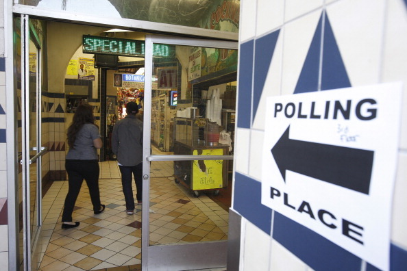 LOS ANGELES, CA - NOVEMBER 6:  A directional sign points the way to a polling place inside El Mercado de Los Angeles, a Mexico-style marketplace in the heavily Latino East L.A. area, during the U.S. presidential election on November 6, 2012 in Los Angeles, California. The election will decide whether Democrat Barack Obama serves a second term as president of the United States or is replaced by Republican rival, former Massachusetts Gov. Mitt Romney.   (Photo by David McNew/Getty Images)