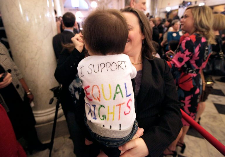   FILE - In this March 1, 2012 file photo, Rep. Anne Kaiser, D-Montgomery, an openly gay member of the Maryland General Assembly, holds Natalie Vincent, 10 months, the daughter of a member of Maryland Gov. Martin O'Malley's staff, after O'Malley signed the Civil Marriage Protection Act in Annapolis, Md. Measures on gay rights and child safety are among the top state laws taking effect at the start of 2013, along with attempts to prevent identity theft and perennial efforts to restrict abortion and illegal immigration. (AP Photo/Patrick Semansky, File)  