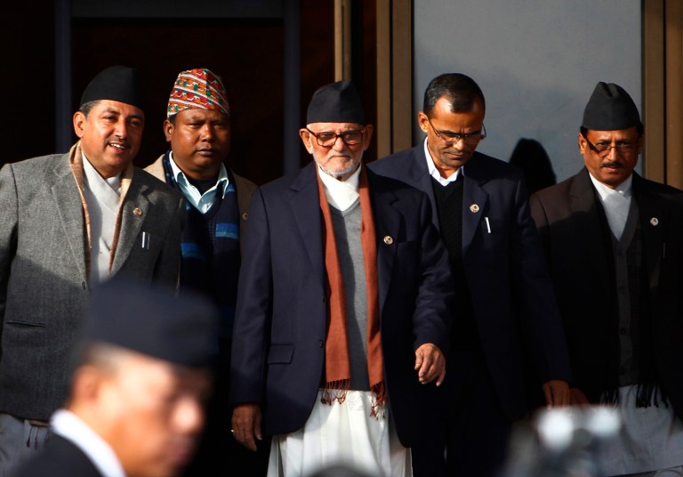FILE - In this Wednesday, Jan. 22, 2014 file photo, Nepali Congress Party President Sushil Koirala, center, returns after the first meeting of the newly elected Constituent Assembly in Katmandu. Koirala, the leader of Nepal's largest political party, is likely to be Nepal's next prime minister as he is the only contender and has enough support to be elected during voting in parliament on Monday, Feb. 10. (AP Photo/Niranjan Shrestha, File)