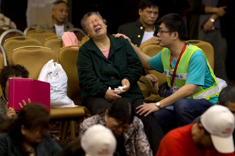 One of relatives of Chinese passengers onboard the Malaysia Airlines Flight 370 grieves at a hotel conference room in Beijing, China, Friday, April 18, 2014. A robotic submarine headed back down into the depths of the Indian Ocean on Friday to scour the seafloor for any trace of the missing Malaysian jet one month after the search began off Australia's west coast, as data from the sub's previous missions turned up no evidence of the plane.(AP Photo/Ng Han Guan)