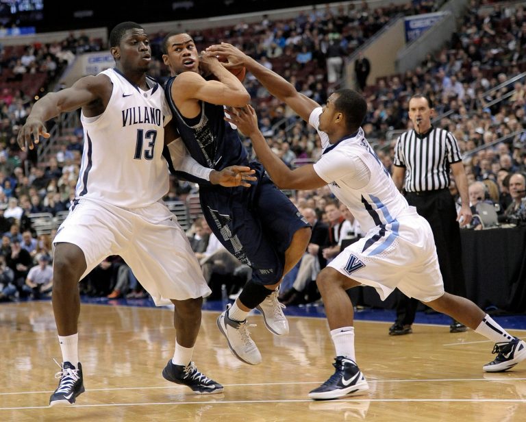 Michael Perez/AP
Georgetown's Markel Starks drives between Villanova's Tony Chennault and Mouphtaou Yarou during the Hoyas' 67-57 loss to Villanova on Wednesday.