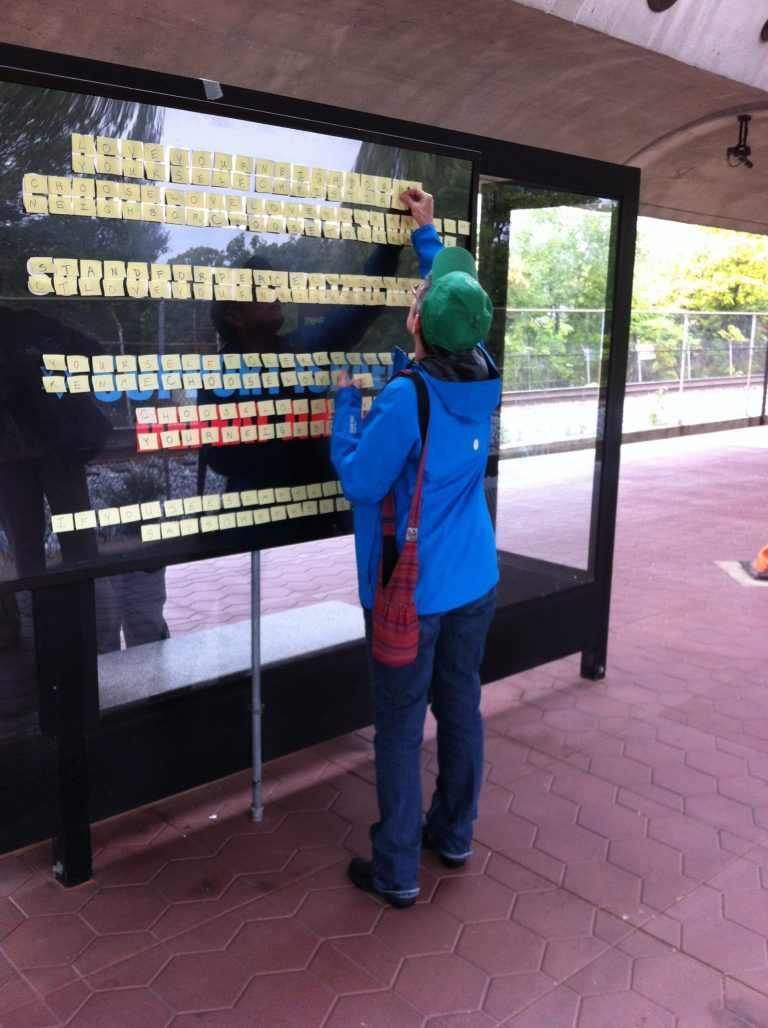 Debbie Polhemus of D.C. counteracts a controversial ad at the Takoma Metro stop using Post-It notes. Metro was ordered by a federal court Friday that it could no longer delay posting the ads, despite concerns about the four ads attracting terrorism or inciting fights. Polhemus' message included: 